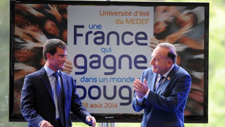 Le Premier ministre Manuel Valls applaudi par Pierre Gattaz à l'université d'été du Medef le 27 septembre 2014 à Jouy-en-Josas [Eric Piermont / AFP]