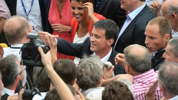 Le Premier ministre Manuel Valls et la ministre de l'Education Najat Vallaud-Belkacem sont accueillis par des militants à l'université d'été à La Rochelle, le 30 août 2014 [Jean-Pierre Muller / AFP]