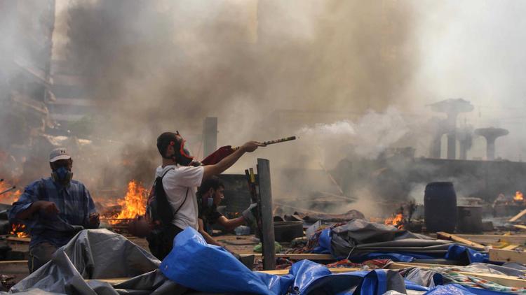 Le 14 août 2013, des militants des Frères musulmans dans une rue du Caire lors de la violente répression policière  [Mosaab El-Shamy / MOSAAB EL-SHAMY/AFP/Archives]