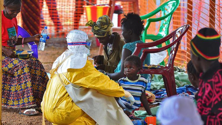 Un employé de MSF donne à manger à un enfant victime d'Ebola, le 15 août 2014 dans le centre de Kailahun, en Sierra Leone [Carl de Souza / AFP]