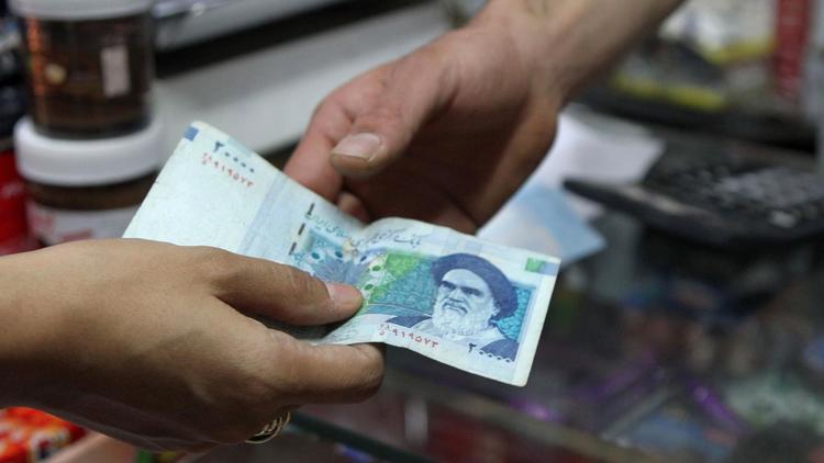Un billet de 20.000 rials iraniens [Atta Kenare / AFP/Archives]