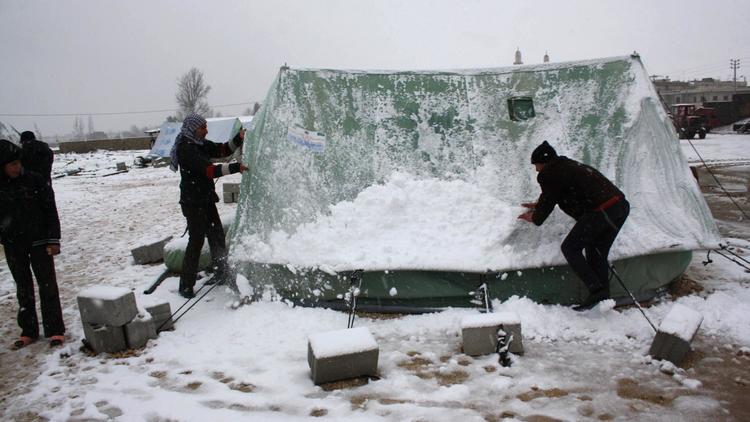 Des réfugiés syriens sous la neige dans un camp de réfugiés au Liban, le 9 janvier 2013 [Hassan Jarah / AFP]