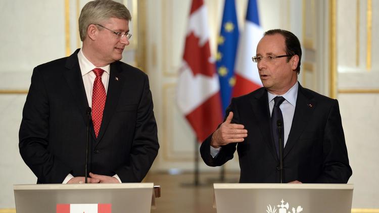 Francois Hollande (d) et le Premier ministre canadien, le 14 juin 2013 lors d'une conférence de presse [Bertrand Guay / AFP]