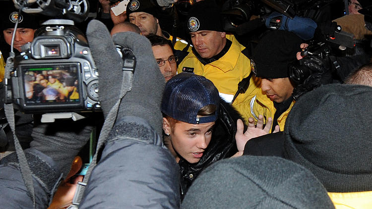 Le chanteur Justin Bieber (c) arrive au poste de police de Toronto, le 29 janvier 2014 [Jag Gundu / Getty/AFP]