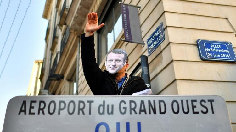 Un manifestant, favorable au projet d'aéroport de Notre-Dame-des-Landes, défile à Nantes avec un masque représentant Emmanuel Macron, le 2 décembre 2017 [LOIC VENANCE / AFP/Archives]