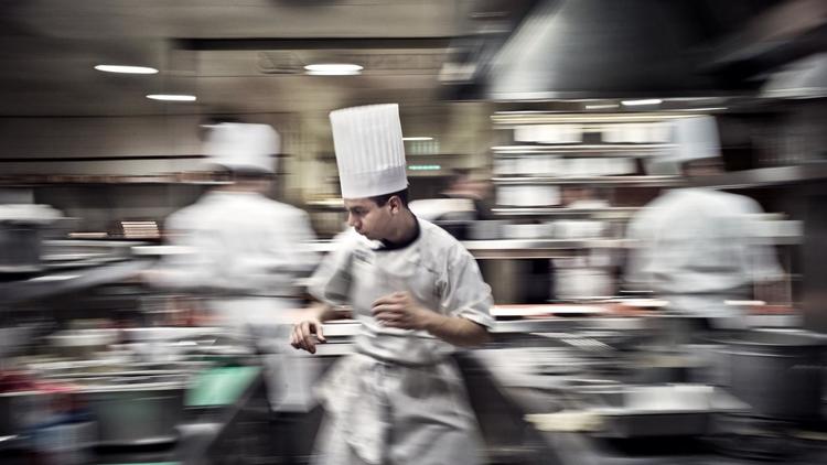 Des cuisiniers au travail dans un grand restaurant [Jeff Pachoud / AFP/Archives]