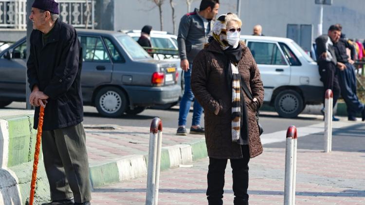 Une Iranienne porte un masque de protection contre le nouveau coronavirus, à Téhéran, le 22 février 2020 [ATTA KENARE / AFP]